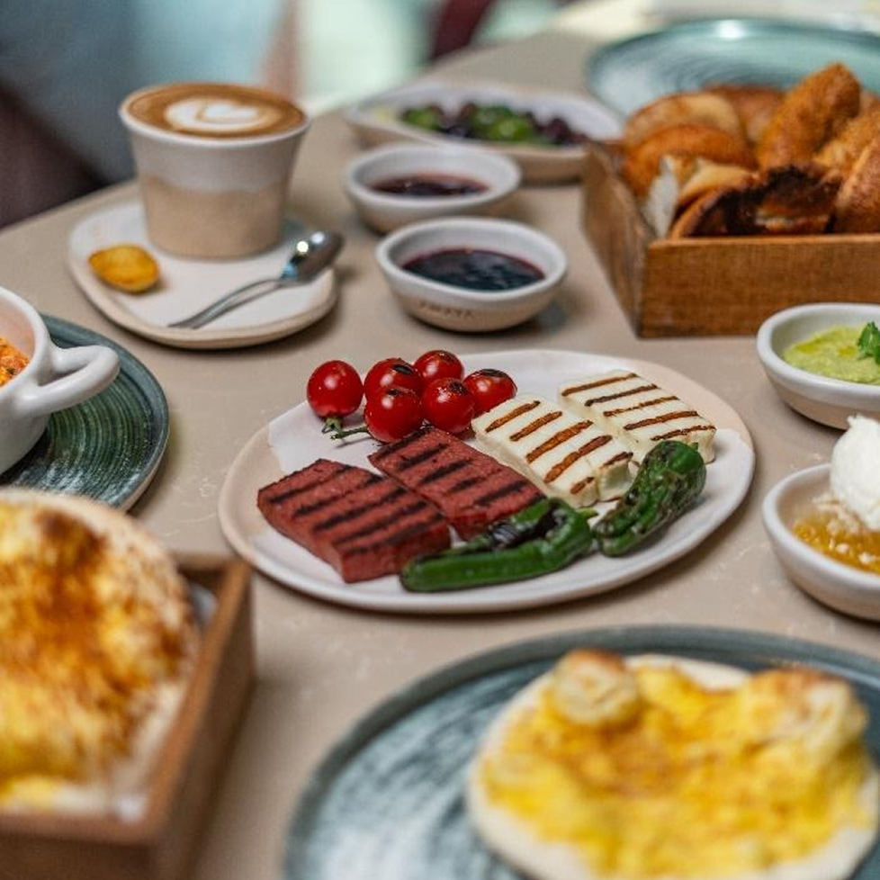 A table filled with Greek food items